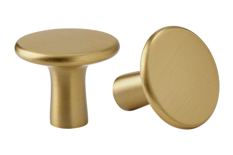 A pair of round cabinet knobs in a satin brass finish
