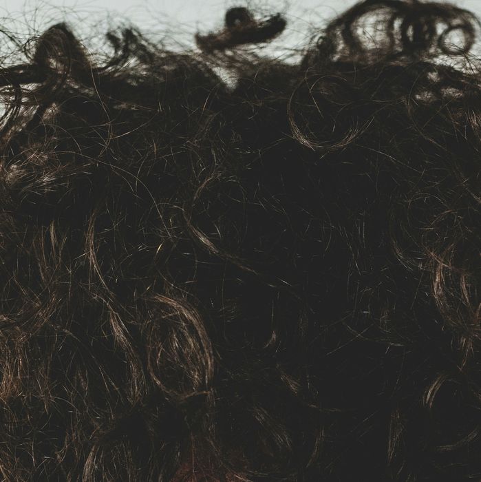 Close-up of a full head of dark curly hair
